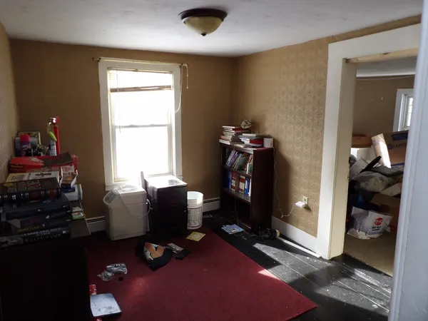 a bedroom with furniture and a window