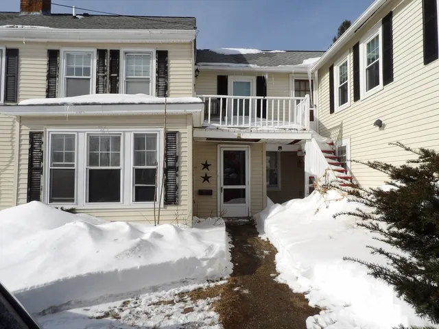 a view of a white house with large windows