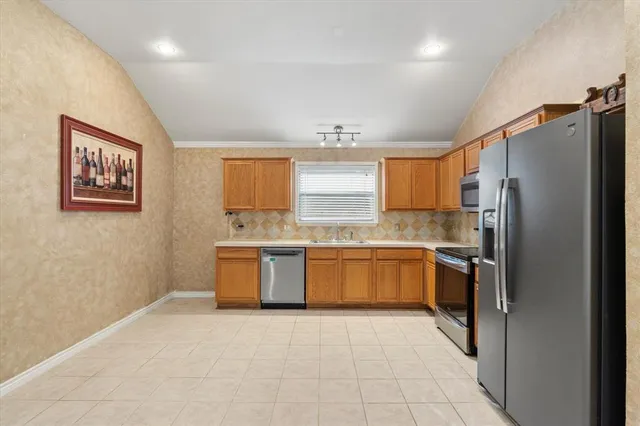 a view of a kitchen with a sink refrigerator and window