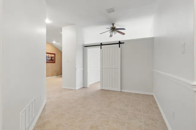 a view of a big room with chandelier fan