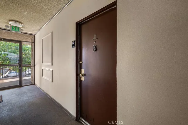 a view of a hallway with windows and entryway