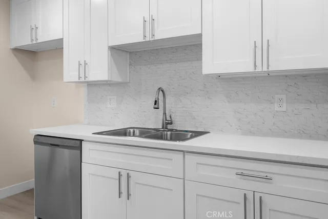 a kitchen with a sink and cabinets
