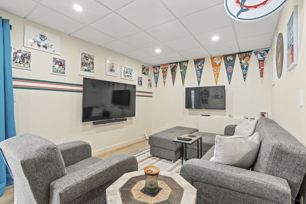 4 Apple Ridge Road, Unit 6 Maynard, MA 01754 - Photo 22 of 40 a living room with furniture and a flat screen tv