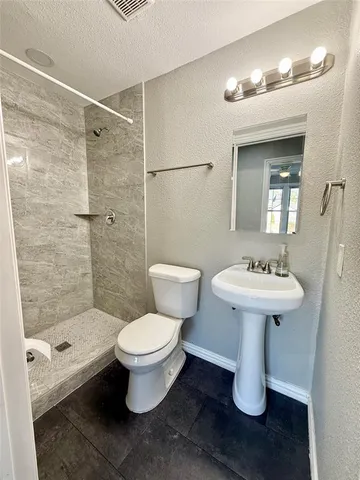a bathroom with a sink toilet and shower