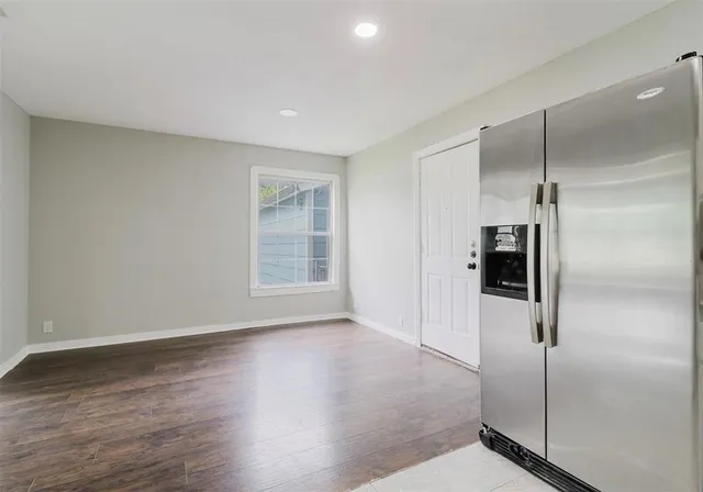 a view of a refrigerator in kitchen and wooden floor