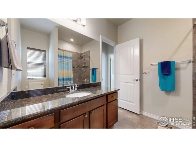 a kitchen with a sink a refrigerator and wooden cabinets