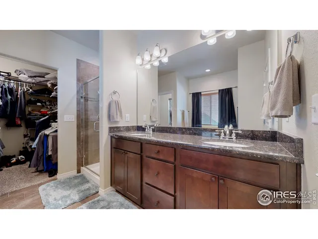 a bathroom with a sink double vanity and a mirror