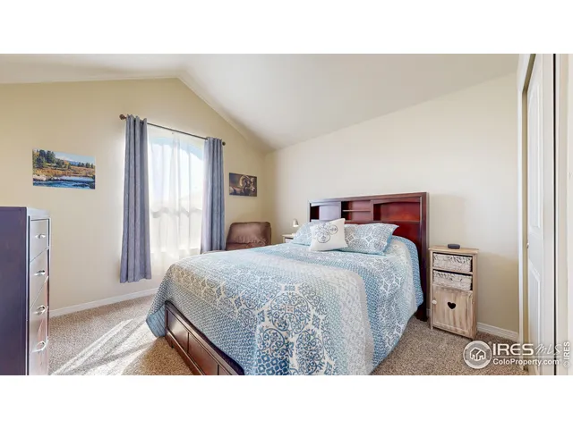 a living room with a bed furniture and a window
