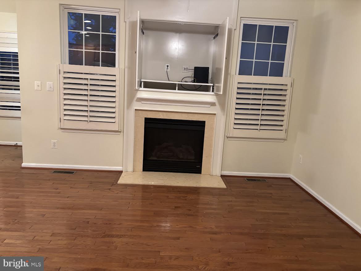 43725 Banshee Heights Terrace Ashburn, VA 20148 - Photo 5 of 30 Family room with built in TV cabinet