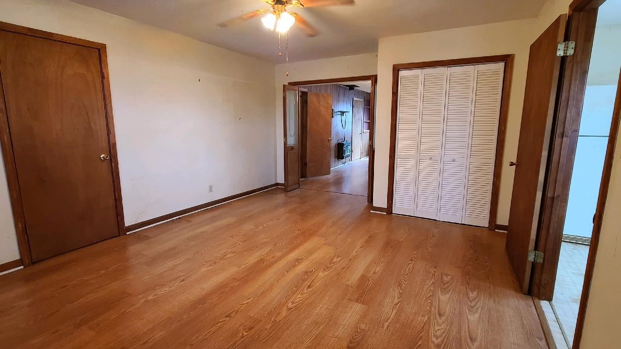 465 Hinkle Road Sardis, TN 38371 - Photo 10 of 24 an empty room with wooden floor and way to kitchen