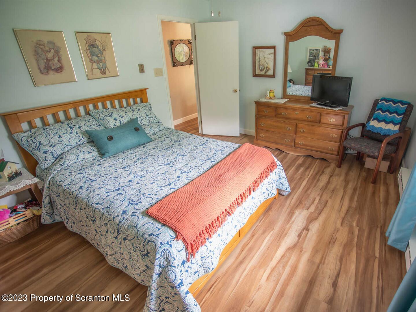 1170 Ridge Road Montgomery, PA 17752 - Photo 17 of 24 a bedroom with a bed and a workspace