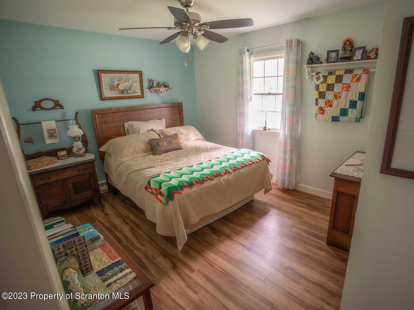 1170 Ridge Road Montgomery, PA 17752 - Photo 18 of 24 a bedroom with a bed and wooden floor