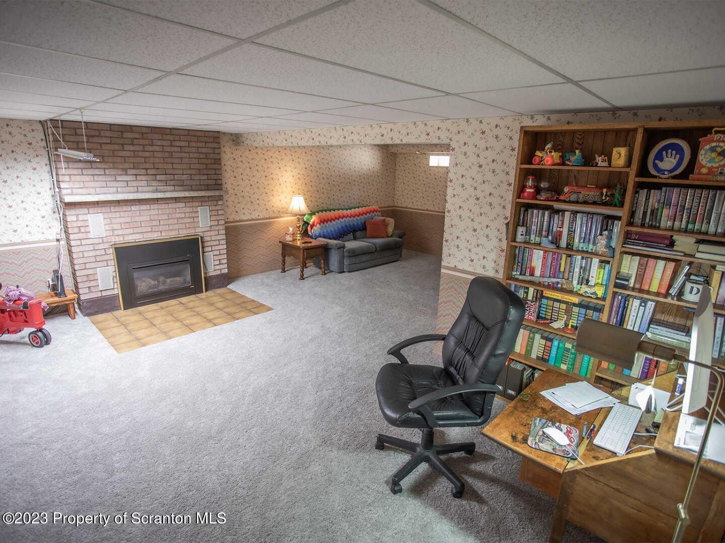 1170 Ridge Road Montgomery, PA 17752 - Photo 19 of 24 a living room with furniture a bookshelf and a fireplace