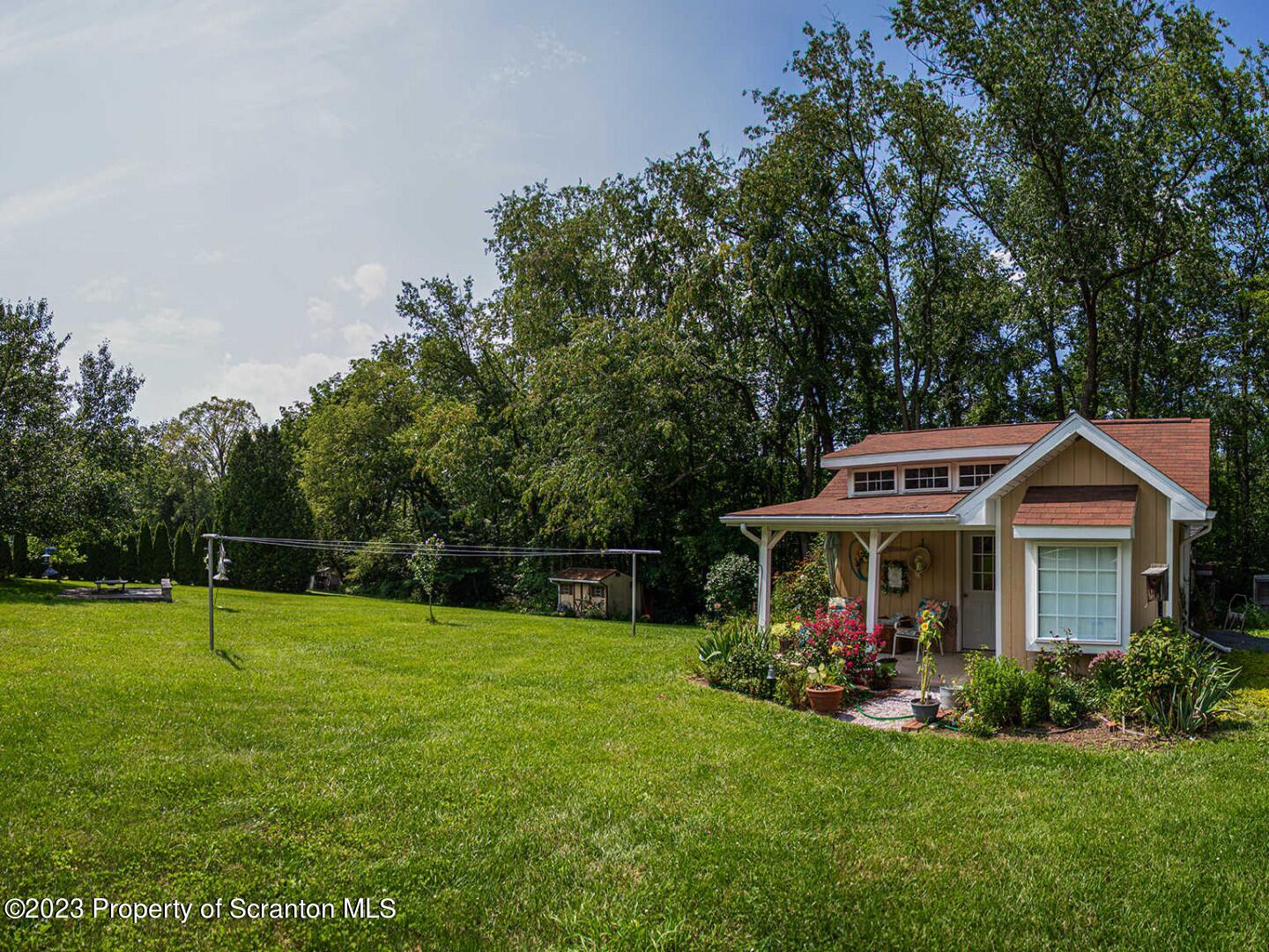 1170 Ridge Road Montgomery, PA 17752 - Photo 23 of 24 a front view of a house with a yard porch and green space