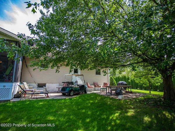 a view of a backyard with sitting area