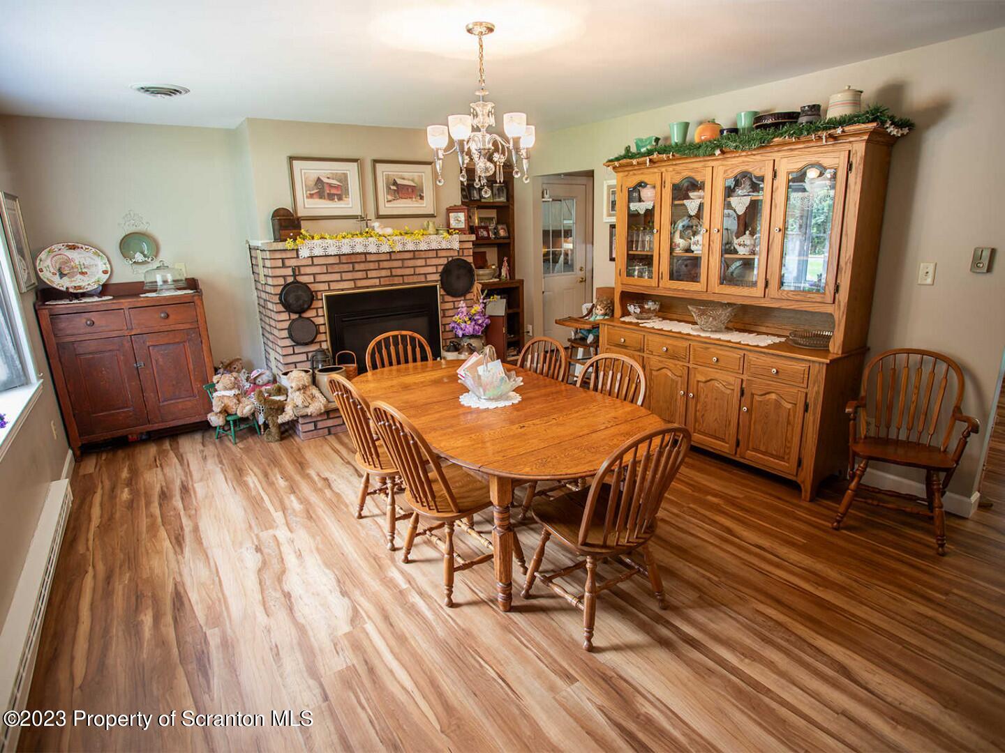 1170 Ridge Road Montgomery, PA 17752 - Photo 6 of 24 a dining room with furniture a chandelier and wooden floor