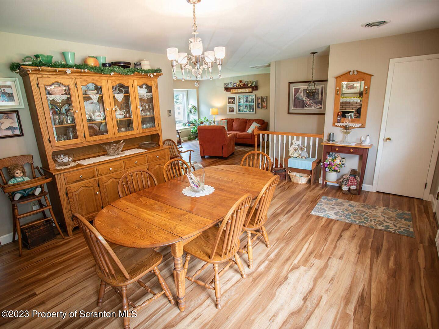 1170 Ridge Road Montgomery, PA 17752 - Photo 7 of 24 a view of a dining room with furniture a chandelier and wooden floor