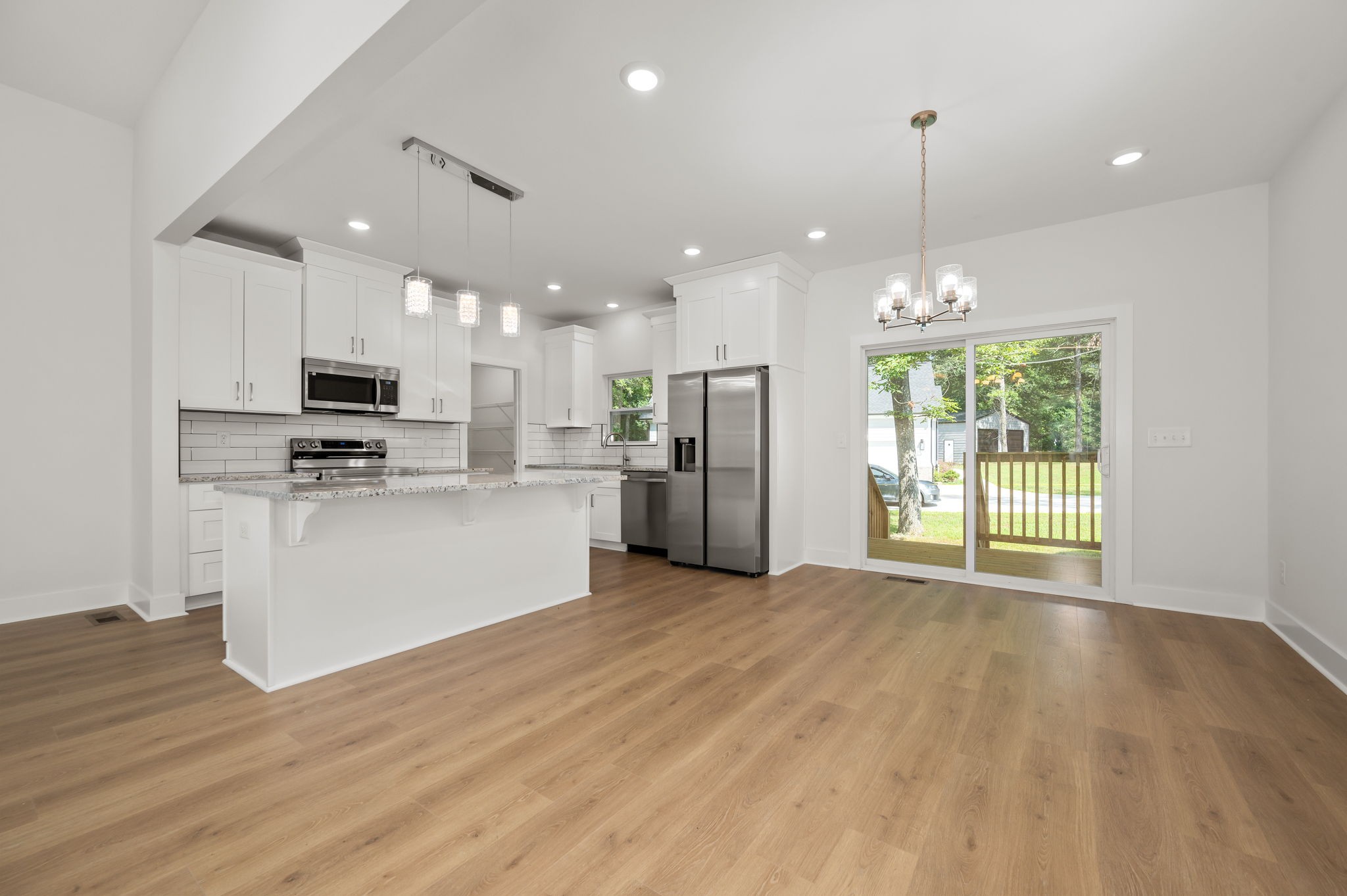 407 Spring Meadows Lane Morrison, TN 37357 - Photo 8 of 25 a view of kitchen with stainless steel appliances granite countertop a refrigerator a oven a stove and a wooden floors