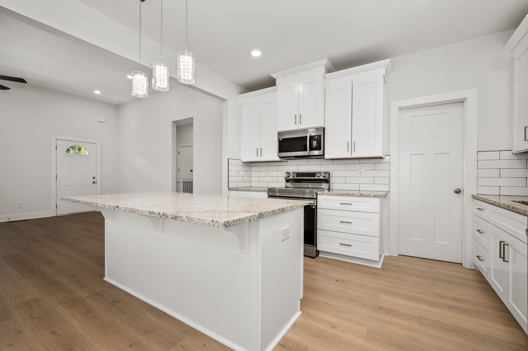 407 Spring Meadows Lane Morrison, TN 37357 - Photo 9 of 25 a kitchen with stainless steel appliances a white stove top oven a sink dishwasher and a refrigerator with wooden floor