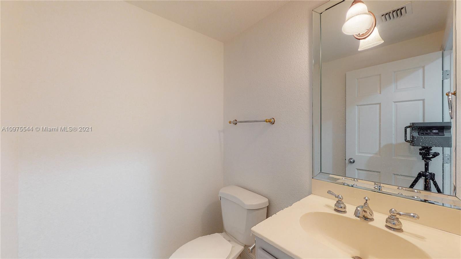 3088 Mary Street, Unit 2 Miami, FL 33133 - Photo 12 of 35 a bathroom with a sink vanity mirror and toilet
