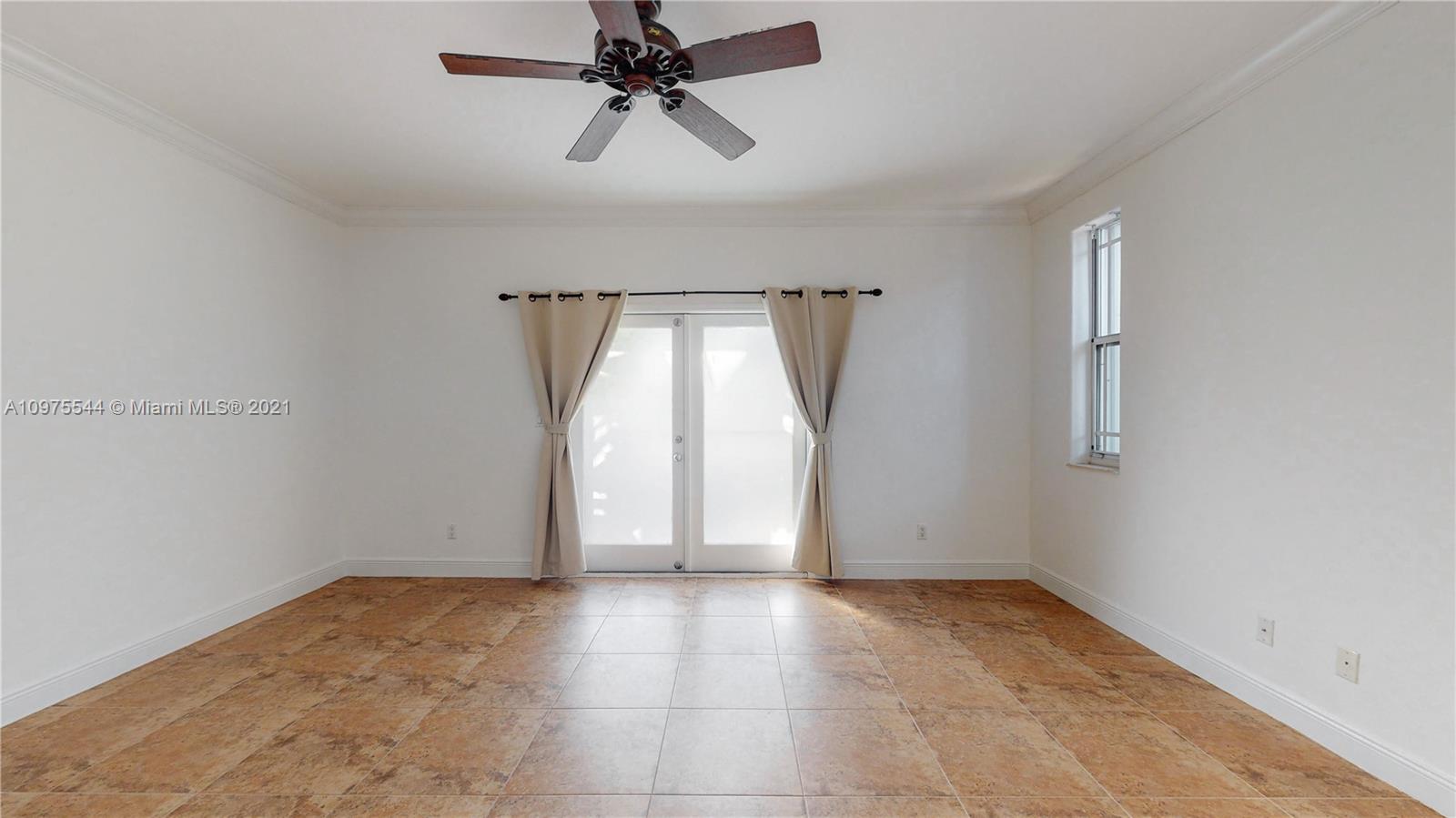 3088 Mary Street, Unit 2 Miami, FL 33133 - Photo 17 of 35 an empty room with windows and fan