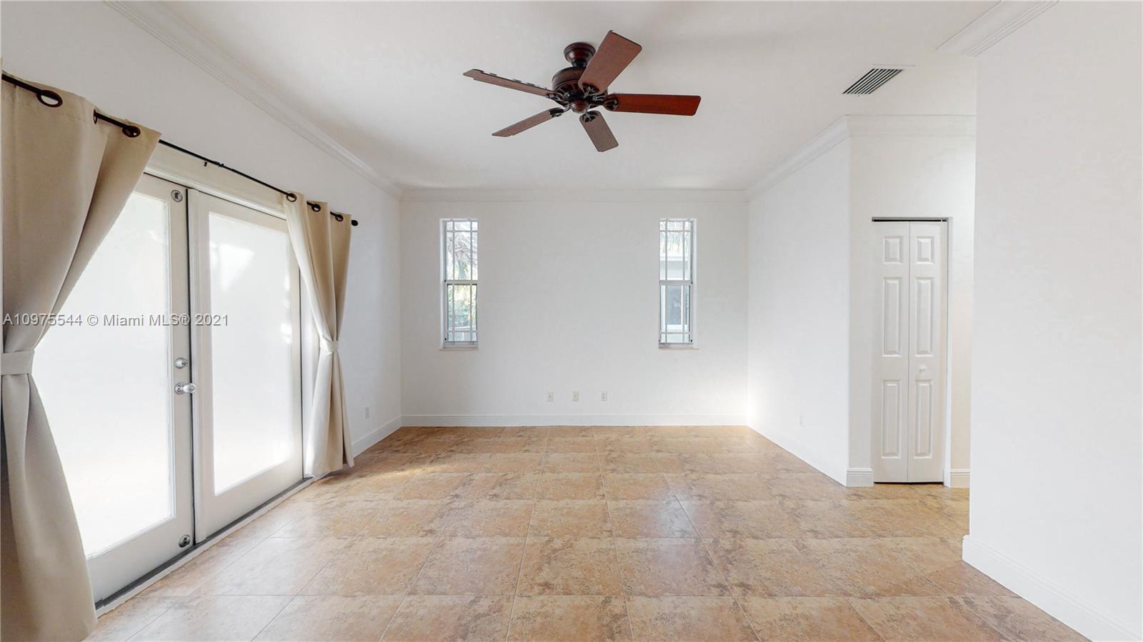 3088 Mary Street, Unit 2 Miami, FL 33133 - Photo 18 of 35 a view of an empty room with a ceiling fan and window