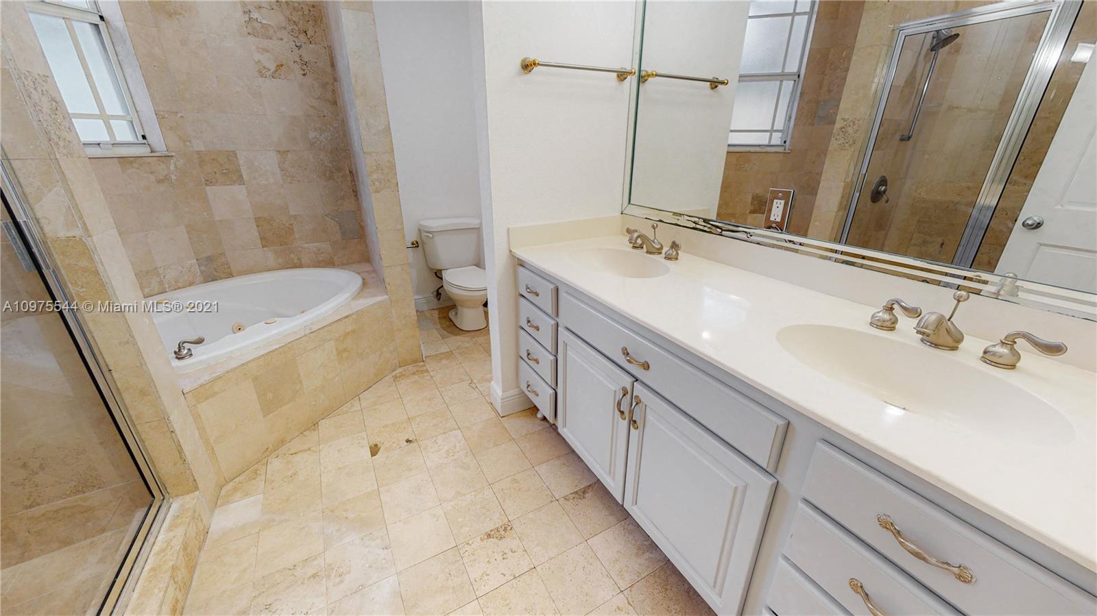3088 Mary Street, Unit 2 Miami, FL 33133 - Photo 19 of 35 a bathroom with a double vanity sink a mirror and a bathtub