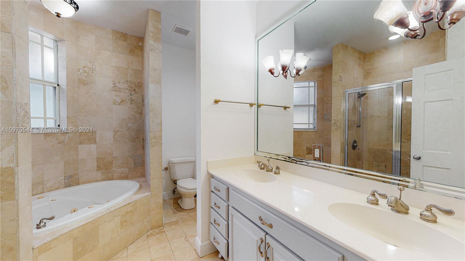 3088 Mary Street, Unit 2 Miami, FL 33133 - Photo 20 of 35 a bathroom with a tub a sink and mirror