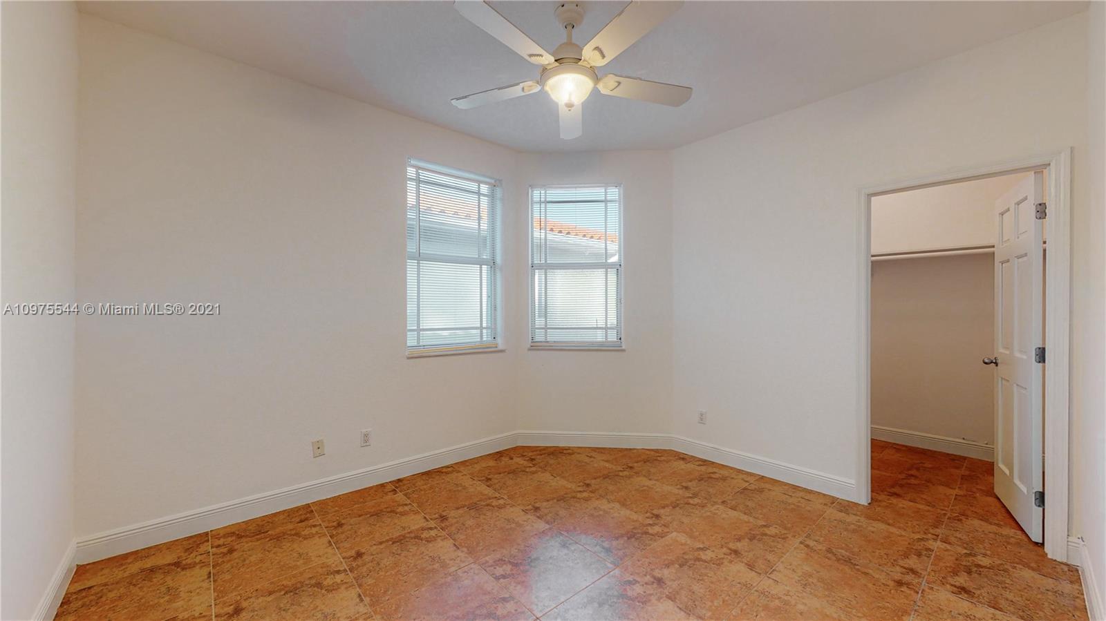 3088 Mary Street, Unit 2 Miami, FL 33133 - Photo 24 of 35 a view of a room with a ceiling fan and a window