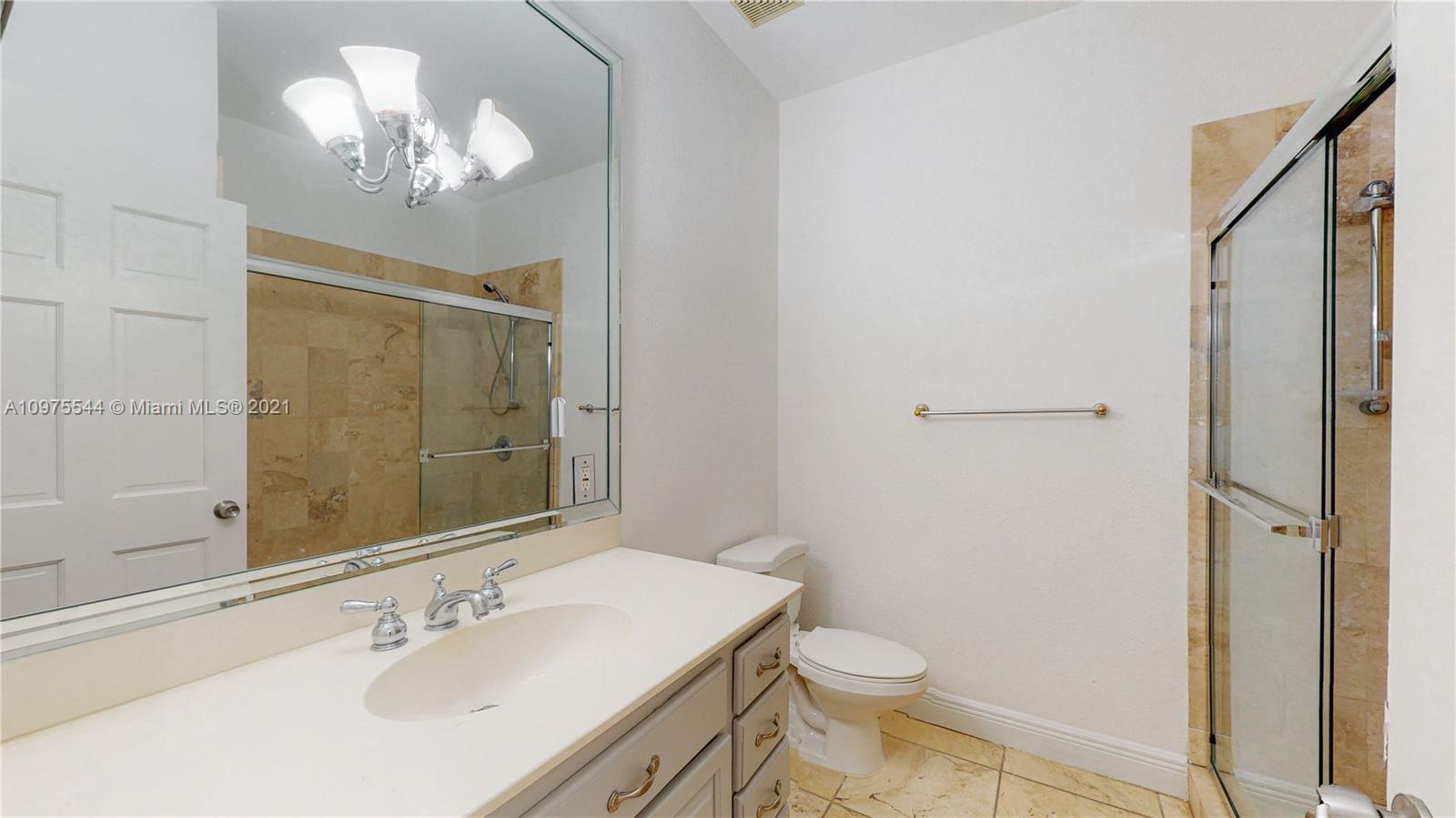 3088 Mary Street, Unit 2 Miami, FL 33133 - Photo 27 of 35 a bathroom with a sink a toilet a mirror and shower