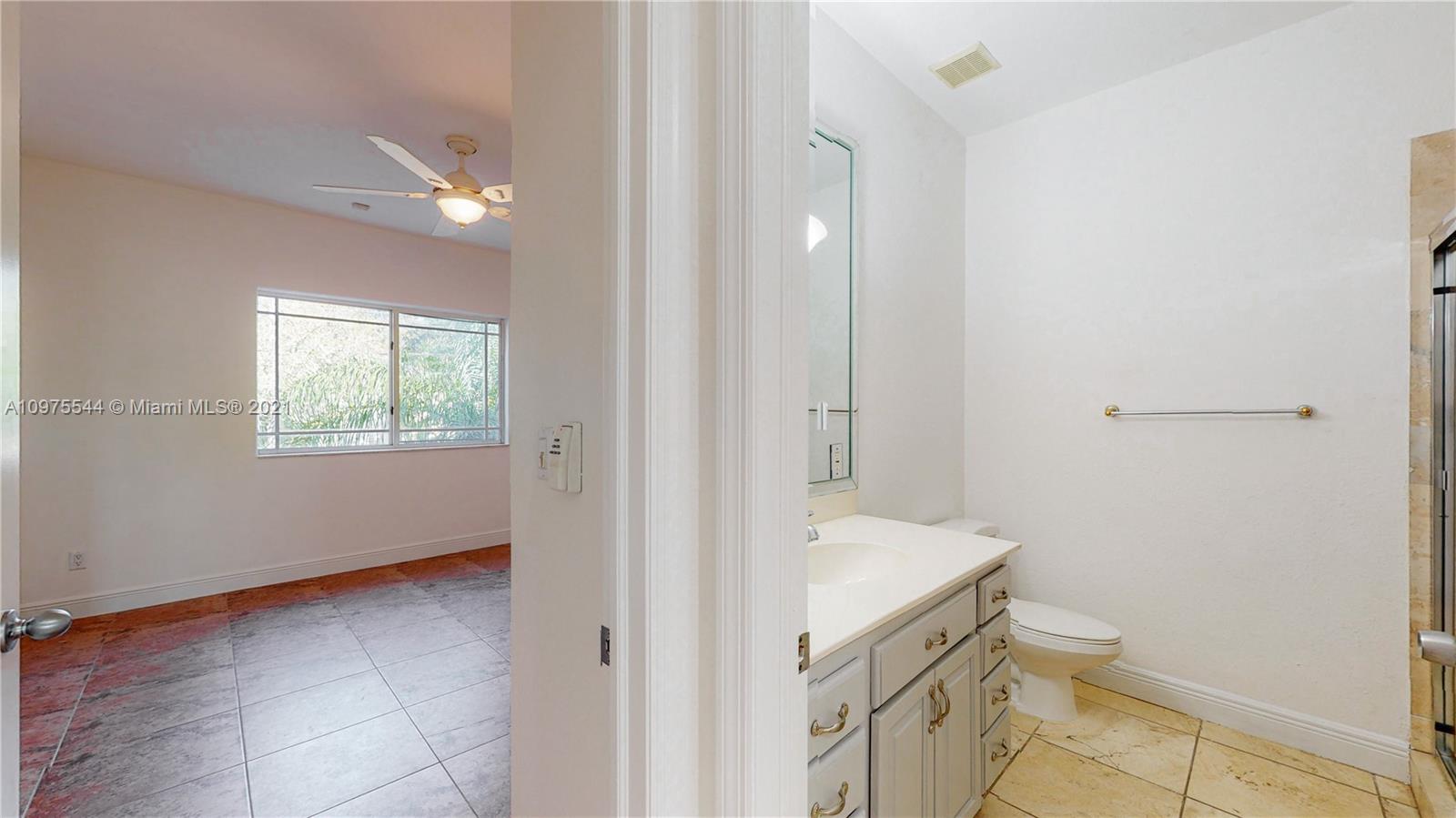3088 Mary Street, Unit 2 Miami, FL 33133 - Photo 28 of 35 a bathroom with a sink a toilet and a window
