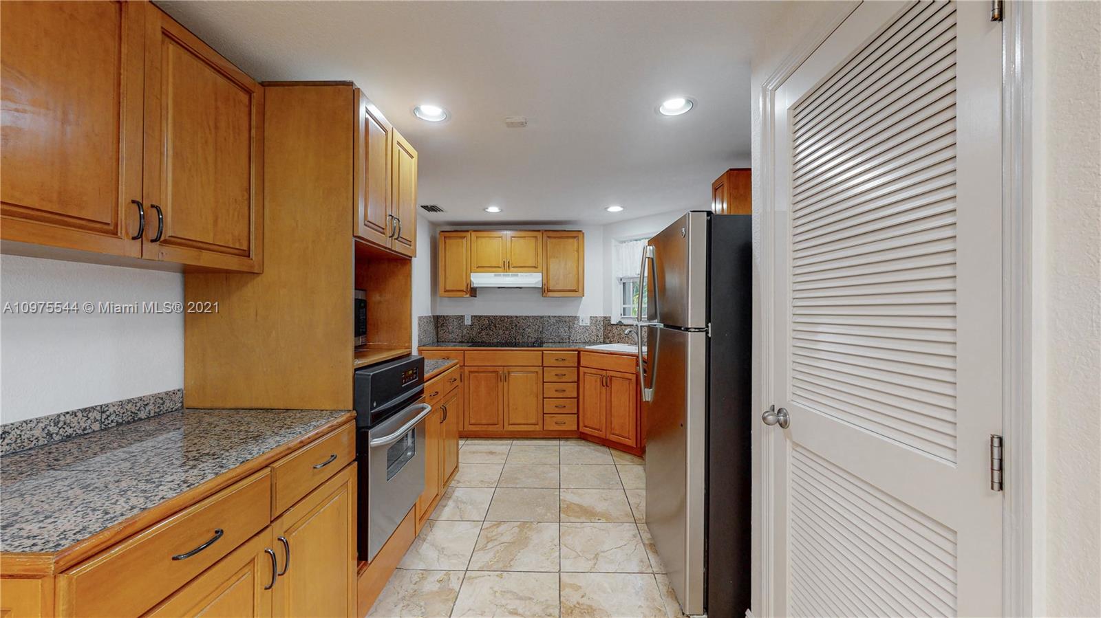 3088 Mary Street, Unit 2 Miami, FL 33133 - Photo 9 of 35 a kitchen with stainless steel appliances granite countertop a refrigerator and a sink