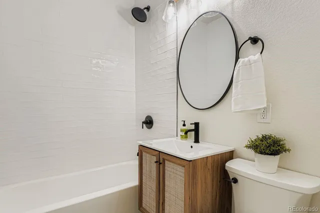 a bathroom with a sink toilet and a mirror