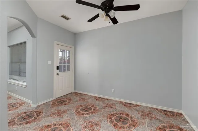 a view of a hallway with a chandelier fan and closet in a room