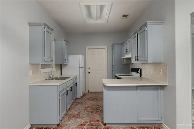 a kitchen with a sink stove and cabinets