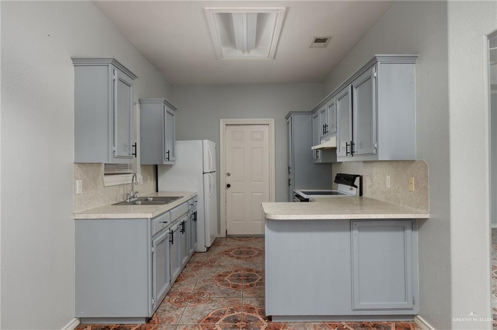 2015 North Ruby Street Edinburg, TX 78541 - Photo 5 of 11 a kitchen with a sink stove and cabinets