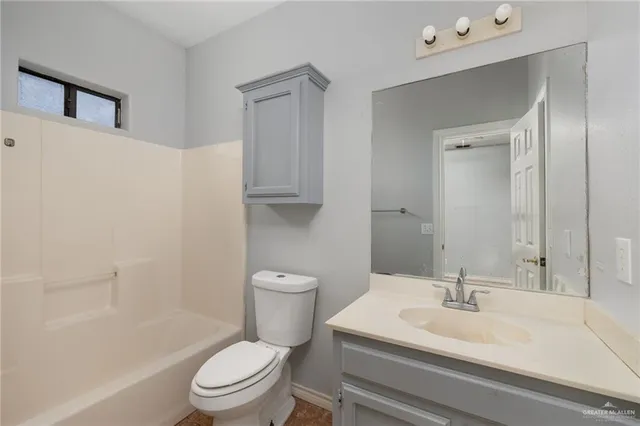 a white toilet sitting next to a bathroom sink