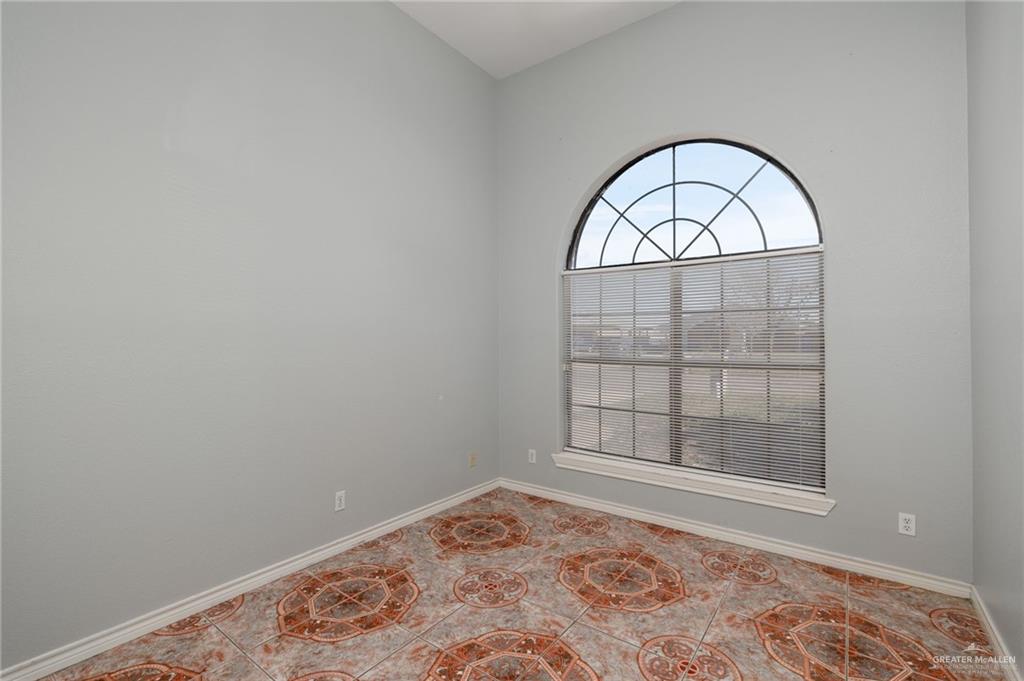 2015 North Ruby Street Edinburg, TX 78541 - Photo 8 of 11 an empty room with wooden floor and windows
