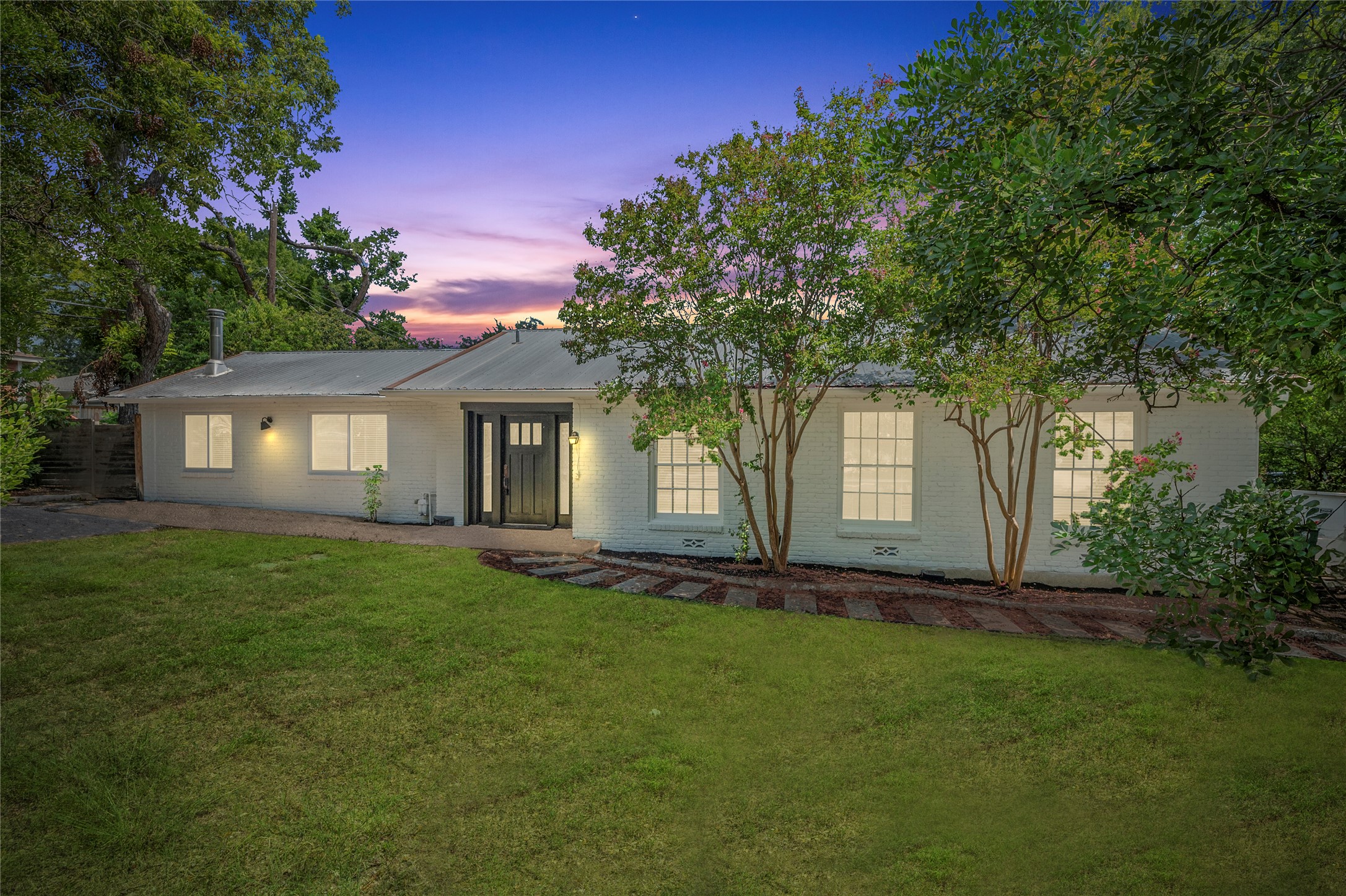2640 West 45th Street Austin, TX 78731 - Photo 1 of 34 Single story home with a metal roof, brick siding, and a front yard