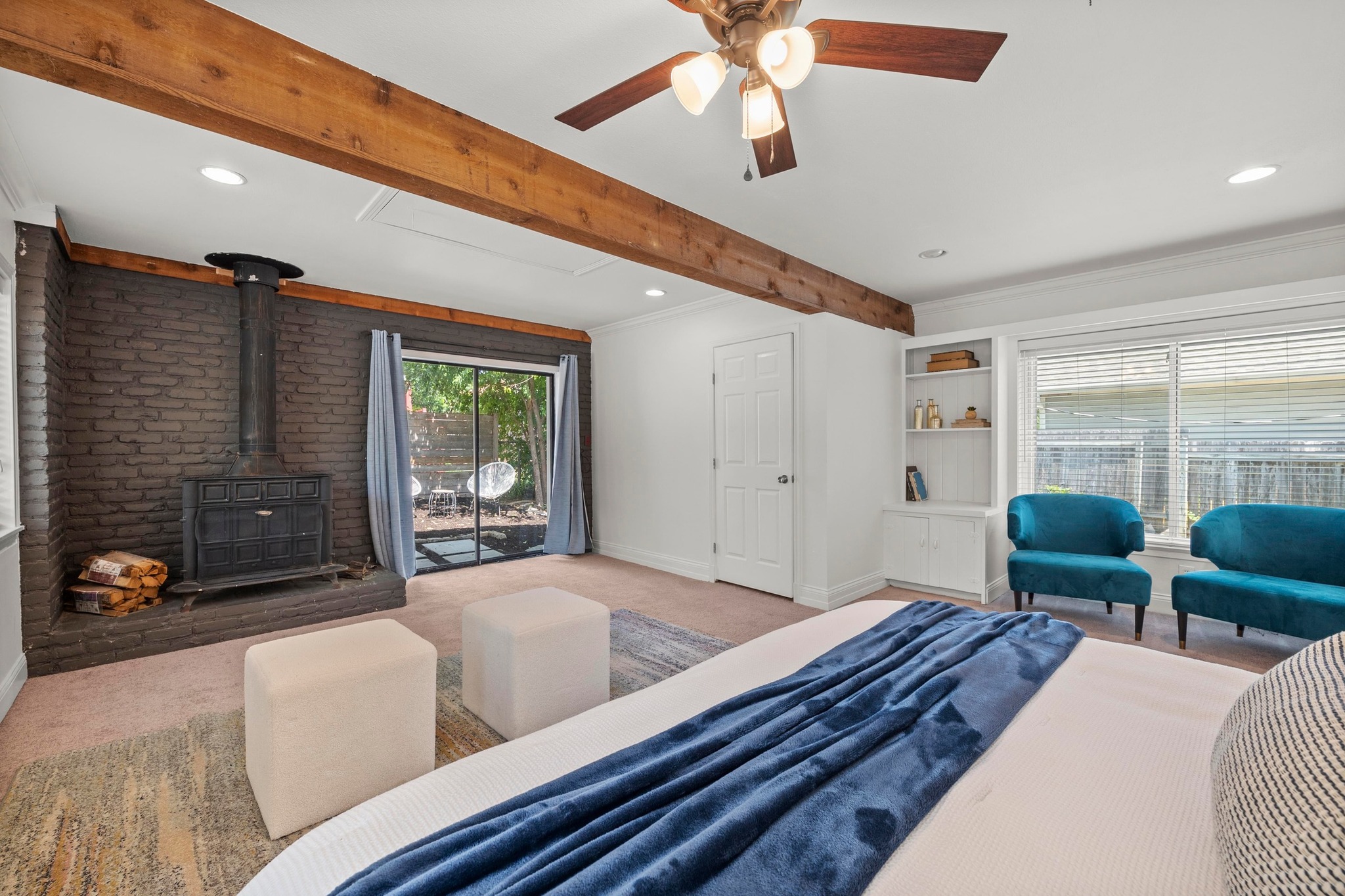 2640 West 45th Street Austin, TX 78731 - Photo 18 of 34 Bedroom with a wood stove, crown molding, beam ceiling, recessed lighting, and access to exterior