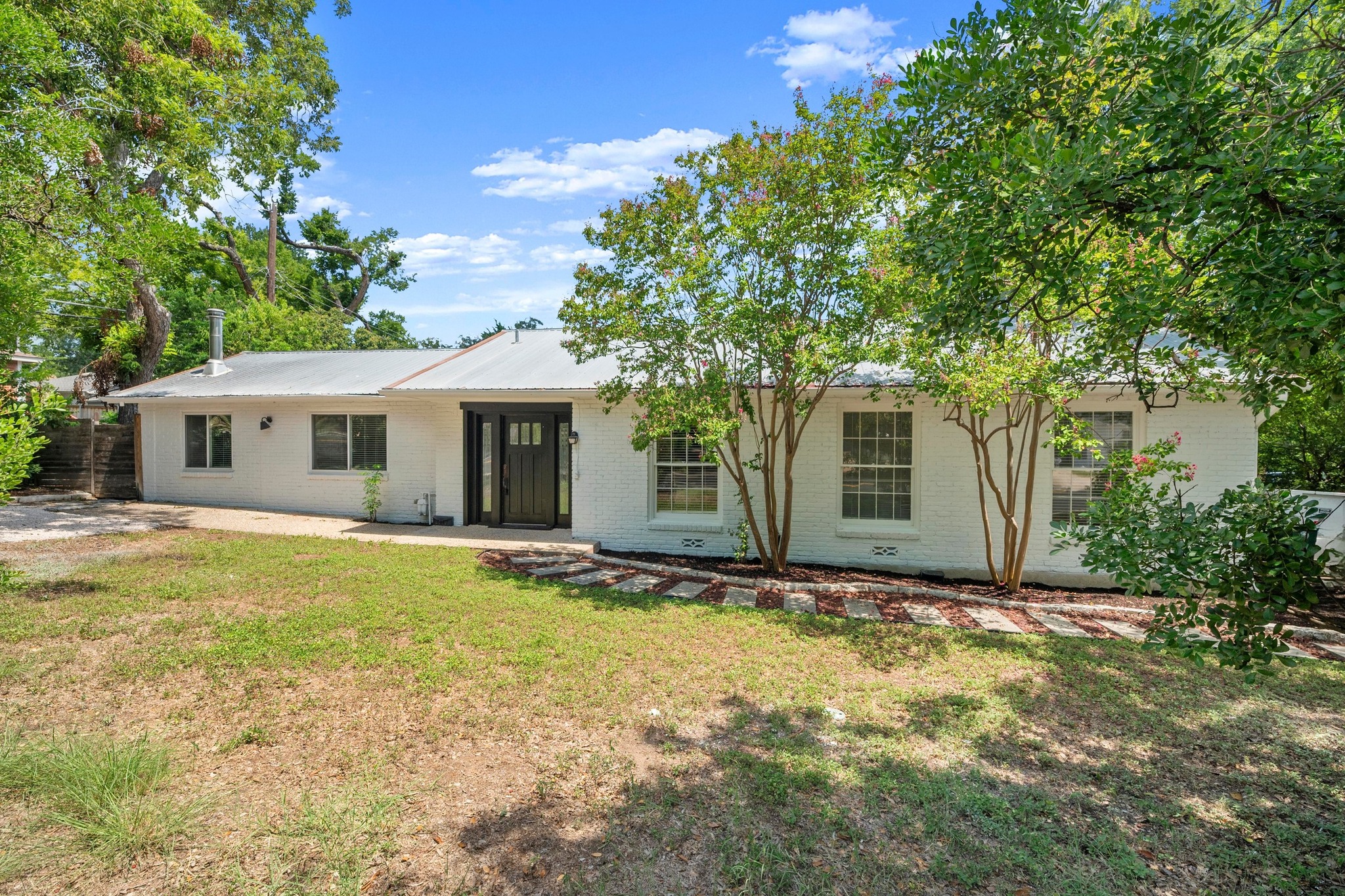 2640 West 45th Street Austin, TX 78731 - Photo 27 of 34 View of front facade featuring brick siding and a patio