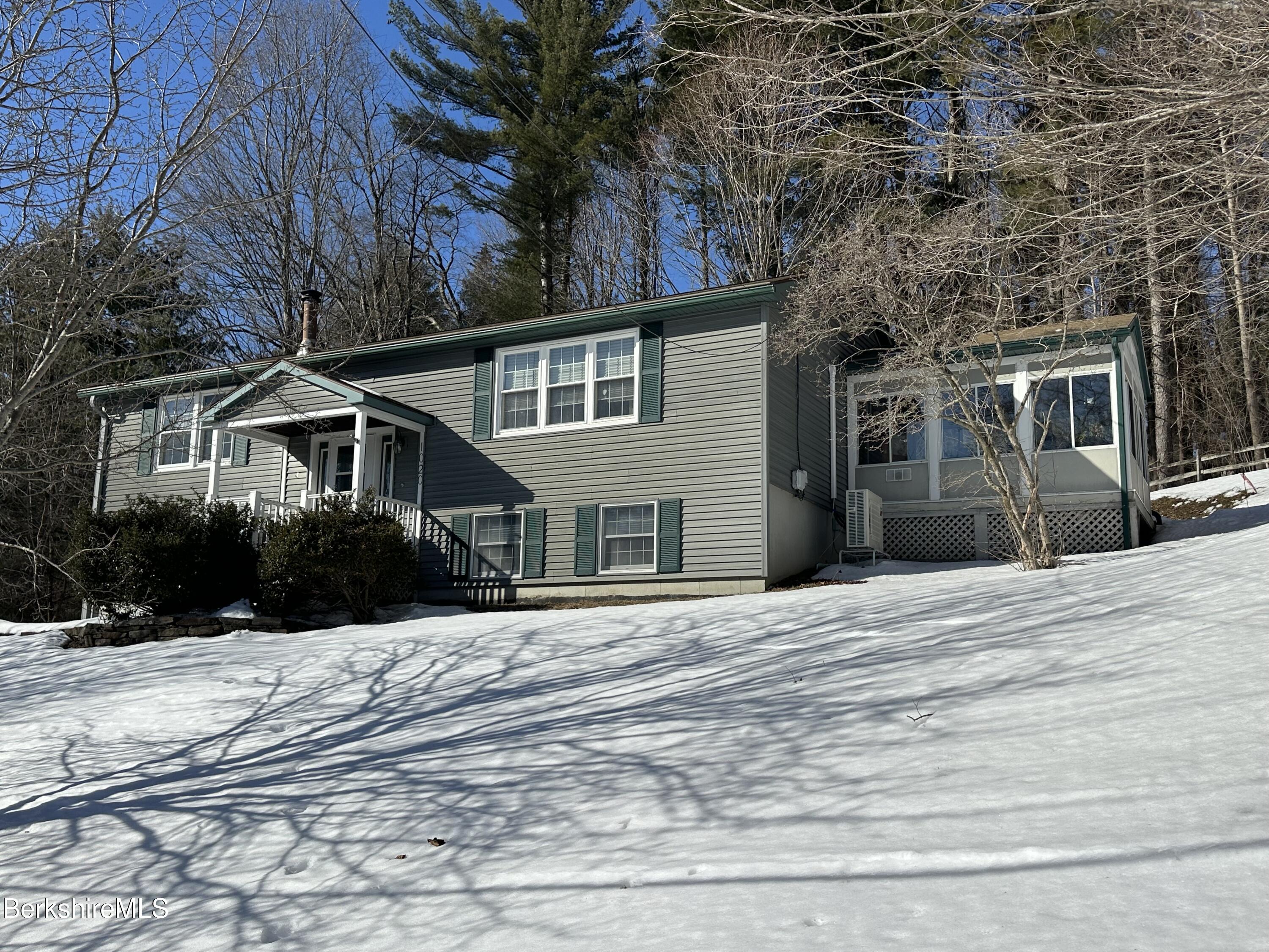 1020 Fairview Street Lee, MA 01238 - Photo 2 of 27 a front view of house with yard and trees around