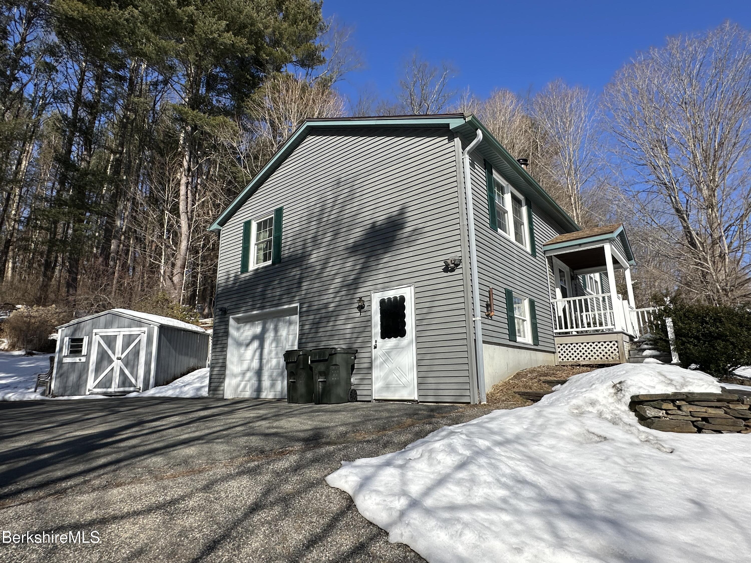 1020 Fairview Street Lee, MA 01238 - Photo 3 of 27 a view of a house with a yard covered in snow