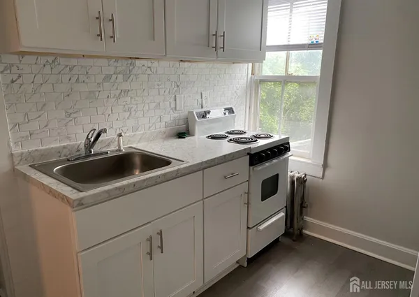 a view of a kitchen with sink and window