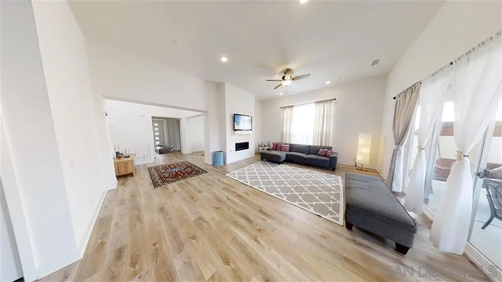 9048 West Bluff Place Santee, CA 92071 - Photo 12 of 14 a spacious bedroom with a bed a couch and a dresser