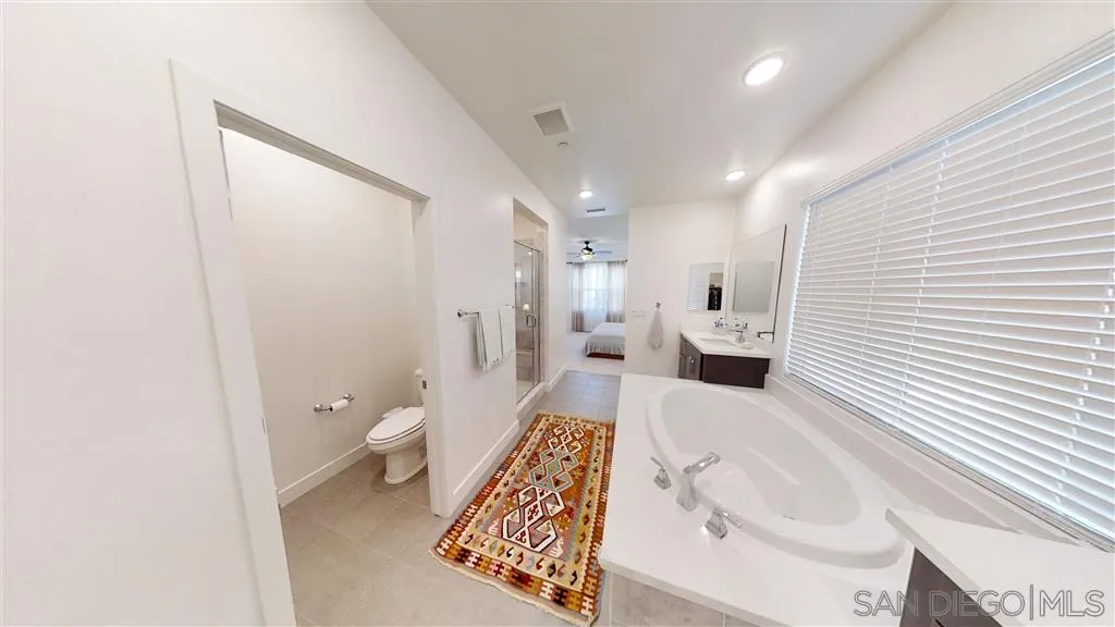 9048 West Bluff Place Santee, CA 92071 - Photo 13 of 14 a spacious bathroom with a bathtub and toilet
