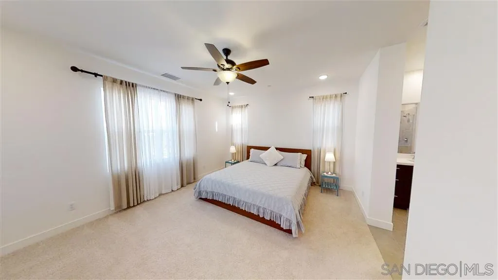 9048 West Bluff Place Santee, CA 92071 - Photo 7 of 14 a spacious bedroom with a bed and a chandelier