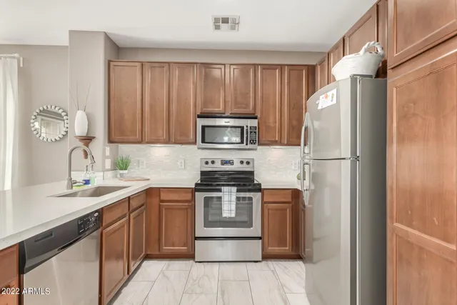 a kitchen with a sink stove and refrigerator