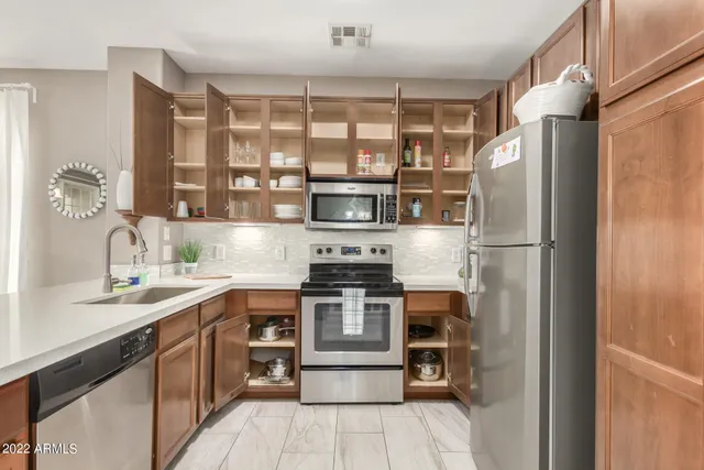 a kitchen with a refrigerator and a sink
