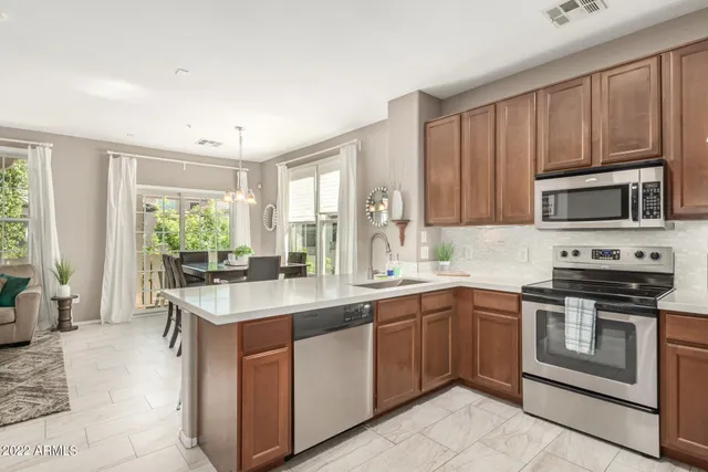 a kitchen with sink cabinets and appliances